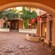 A courtyard filled with trees, plants and storefronts